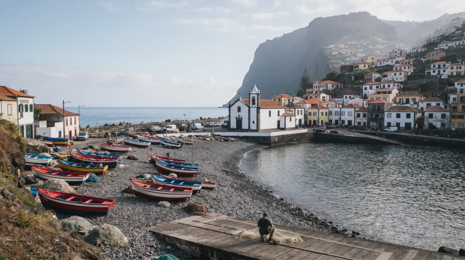 Camara de Lobos bay with colourful xavelha fishing boats below the town, Madeira, Portugal