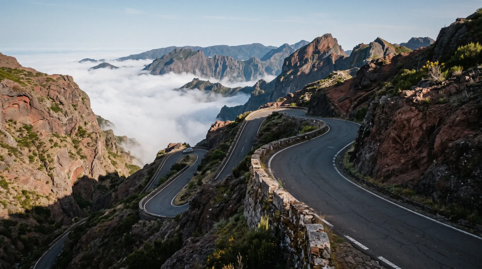 A hire car on a mountain road above the clouds, showing car hire in Madeira