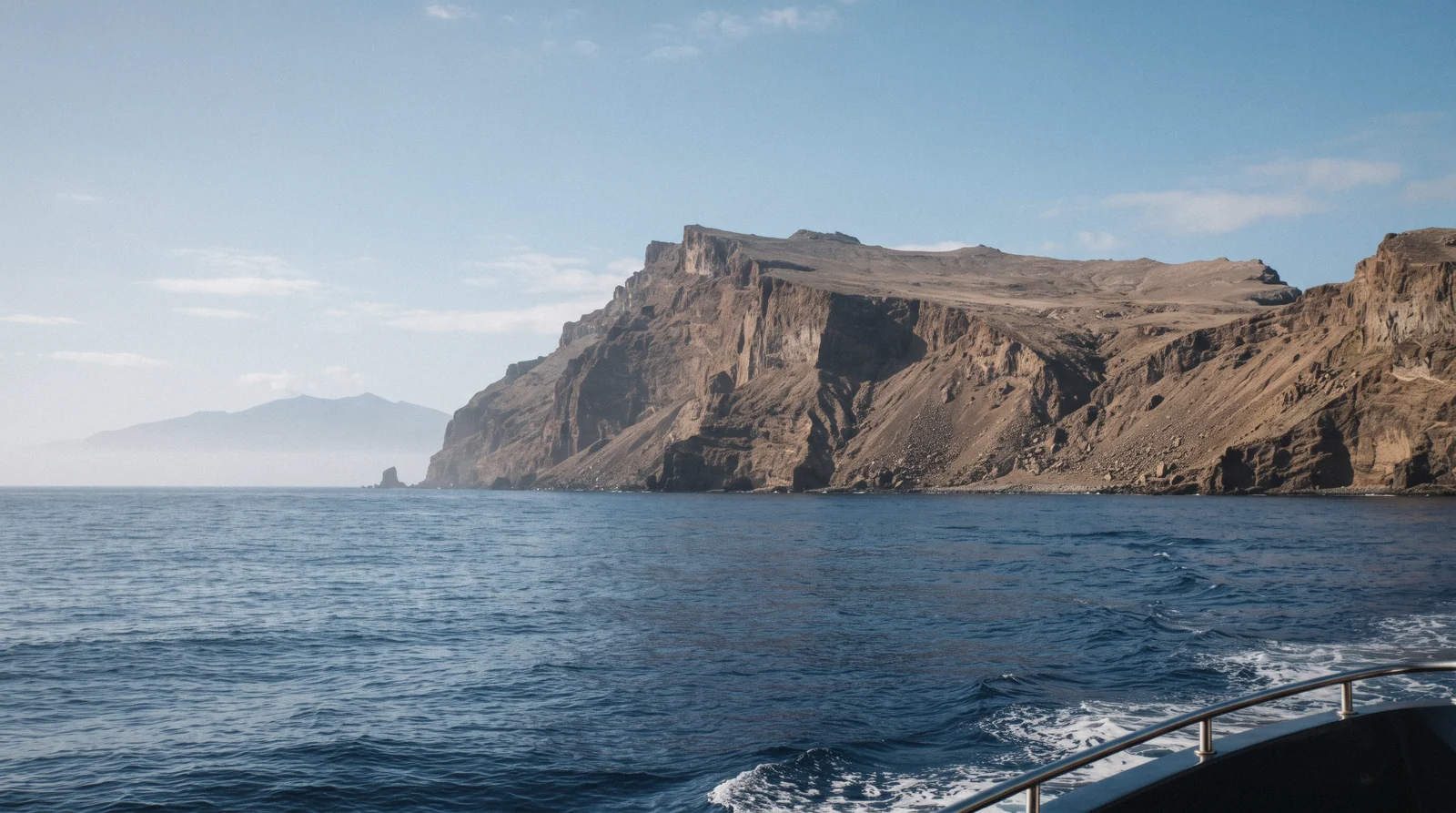 The tall volcanic cliffs of the Desertas Islands nature reserve seen from the sea near Madeira, Portugal