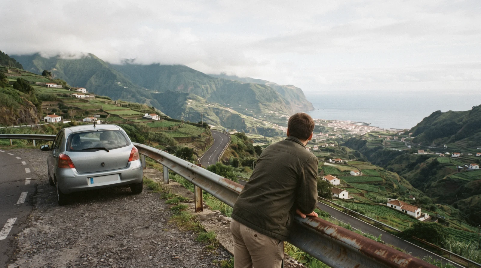 A hire car in a mountain lay-by above the terraced valley of São Vicente on the north coast, Madeira, Portugal