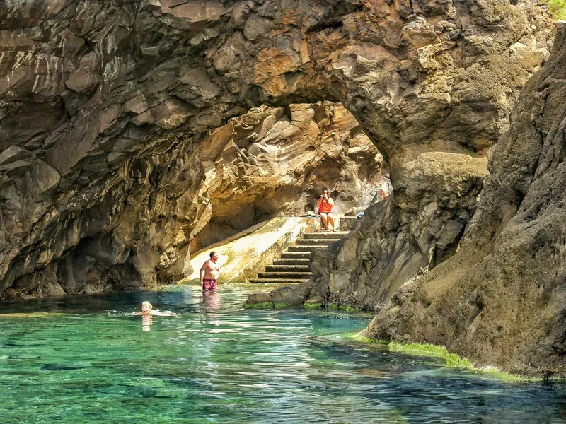 Bathers in the black volcanic saltwater pools of Porto Moniz on an Enchanted Terraces 4WD tour in Porto Moniz, Madeira