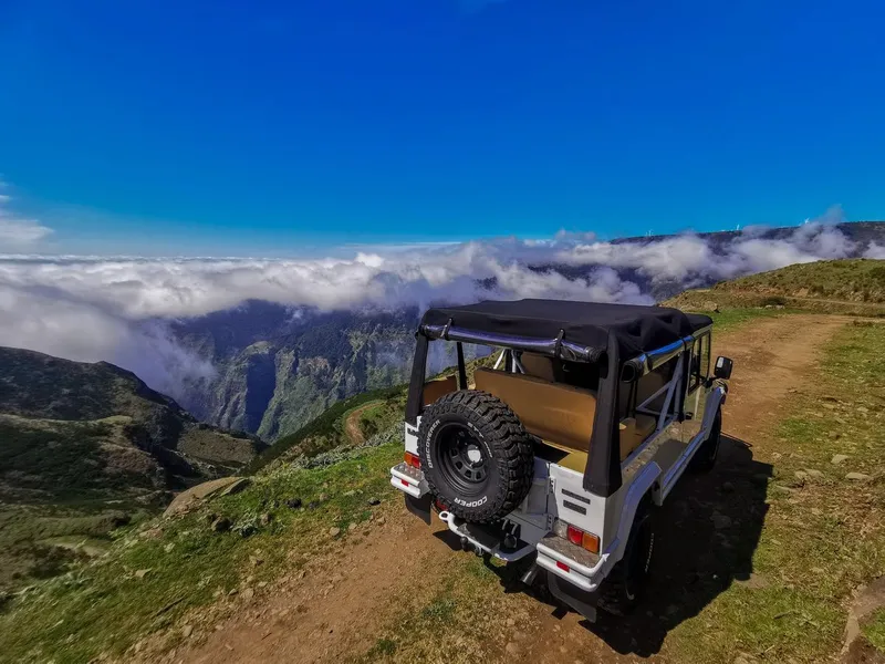 Waves breaking over the black volcanic natural pools of Seixal on a Madeira full-day jeep tour in Seixal, Madeira