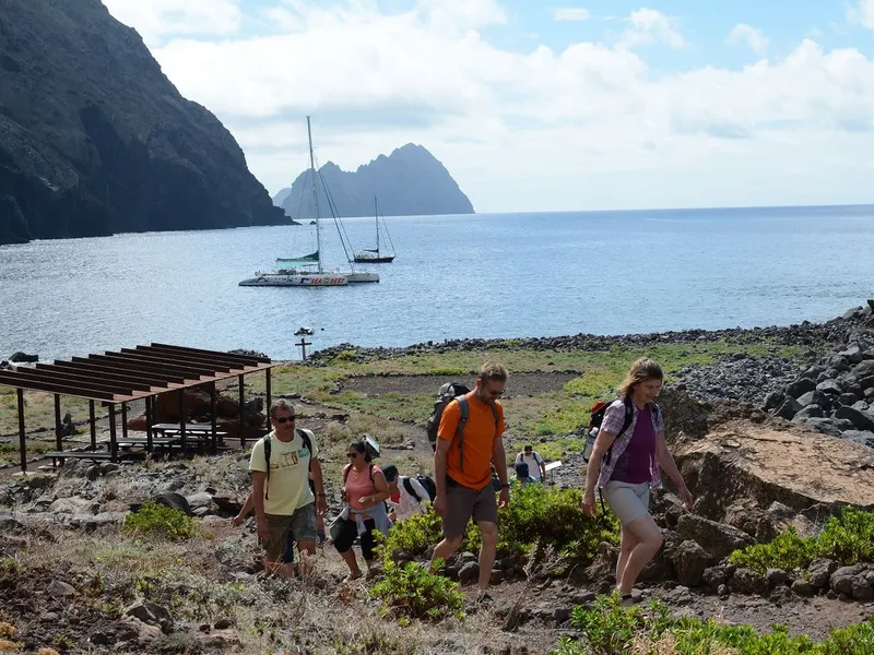 A catamaran sailing past the tall cliffs of the uninhabited Desertas Islands on a full-day catamaran trip from Funchal in Desertas Islands, Madeira